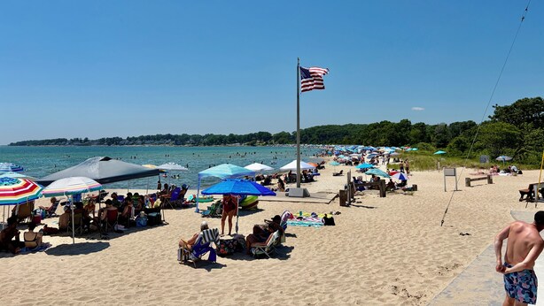 A beach with umbrellas, people, and an American flag. - Beach Ready 3-bdrm house, Short Walk to Private Beach and Park, Lots of Parking (Niantic)
