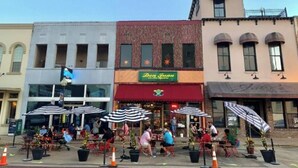A restaurant with outdoor seating and a red awning. - Dreaming Rose City Getaway! (Tyler)