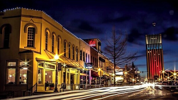 A historic building with arched windows and a marquee sign. - Dreaming Rose City Getaway! (Tyler)
