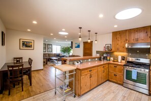 Enjoy cooking in this well-equipped kitchen with a central island, dining area, and large window.