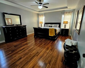 A bedroom with a bed, dresser, and ceiling fan. - 🌟"Home-Away-From-Home" Beauty; Kid, Baby & Dog-Friendly; Veteran-Owned🌟 (Sanford)