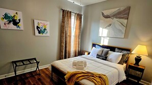 A neatly made bed with a headboard, a bedside lamp, and a nightstand. - 🌟"Home-Away-From-Home" Beauty; Kid, Baby & Dog-Friendly; Veteran-Owned🌟 (Sanford)
