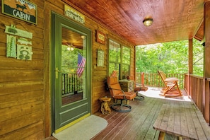 A wooden cabin with a porch, a welcome sign, and a sign indicating the cabin is for sale. - Cozy Cabin Hot tub Firepit Game Room Pool Table Gas Fireplace 5 min to GB-PF (Sevierville)