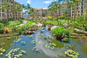 Escape to a tranquil oasis surrounded by lush plants and a serene pond.