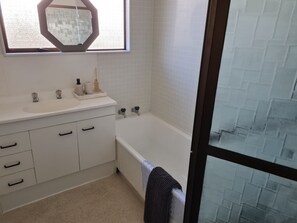 Bathtub, hair dryer, towels, soap