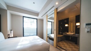A modern hotel room with a large bed, a bathroom with a checkered floor, and a large window providing natural light. - KOKO HOTEL Premier Kanazawa Korinbo (Kanazawa)