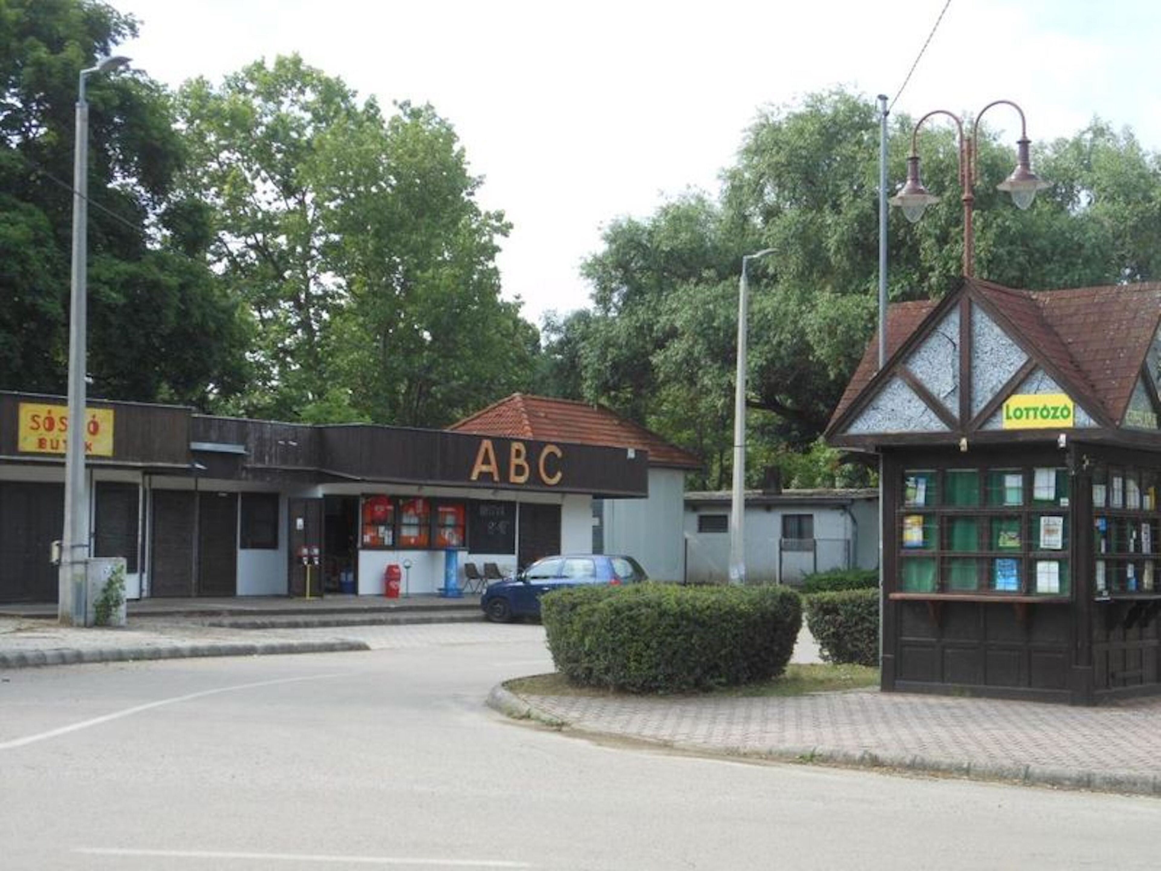 A street view with a building labeled 'ABC' and a small structure labeled 'Lottozo'.
