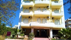 A multi-story building with balconies, air conditioning units, and a sign reading "ALKIONI". - Alkioni City Apartments (Chania)