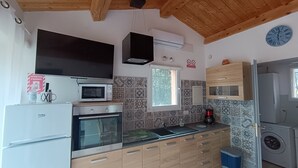 Cozinha compacta com micro-ondas, forno e armários embutidos.