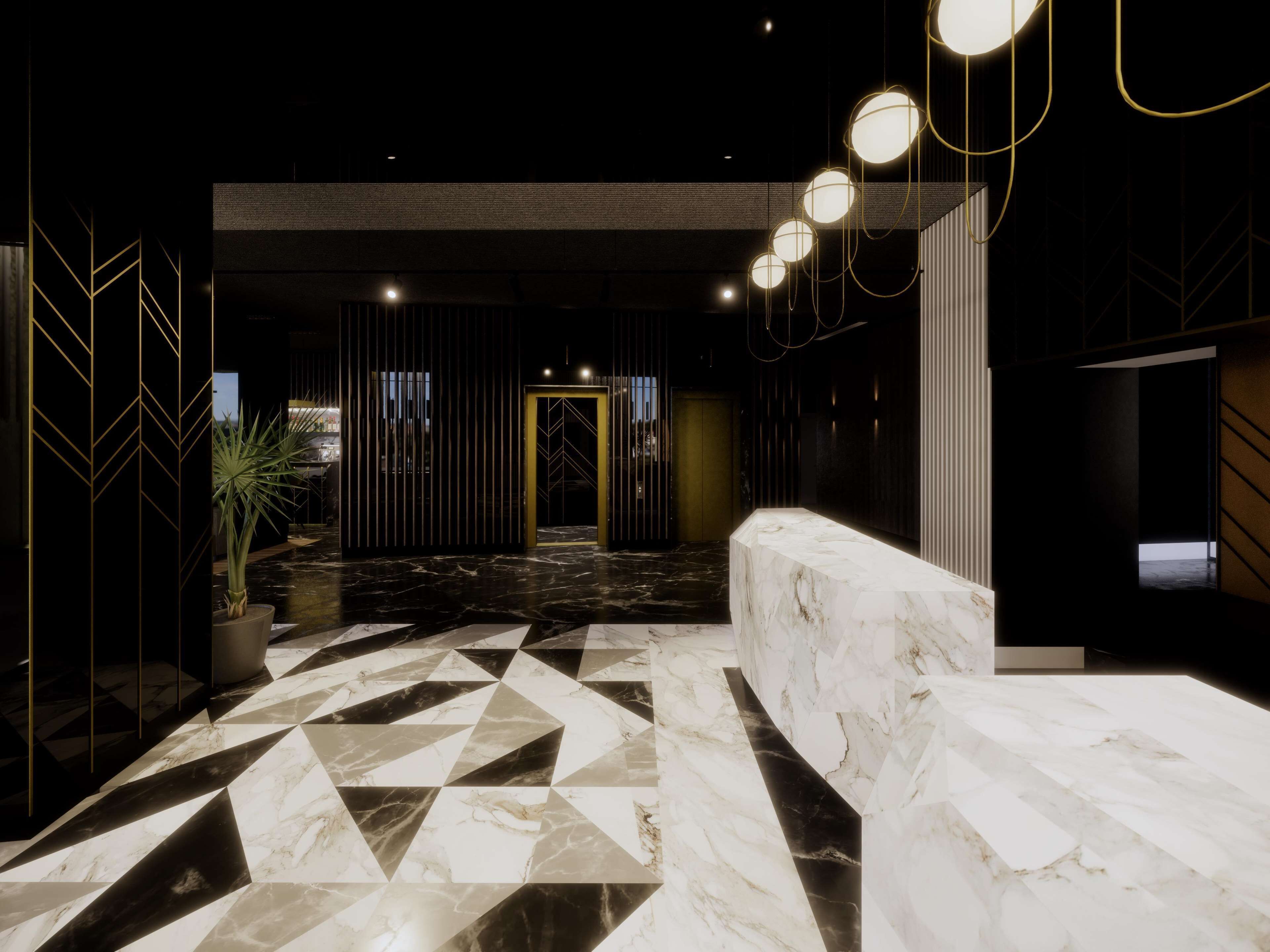 A modern lobby with a geometric marble floor, a reception desk, and a dark, striped wall with a golden door.