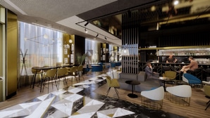A modern bar area with seating, a bar counter, and a view of the city.