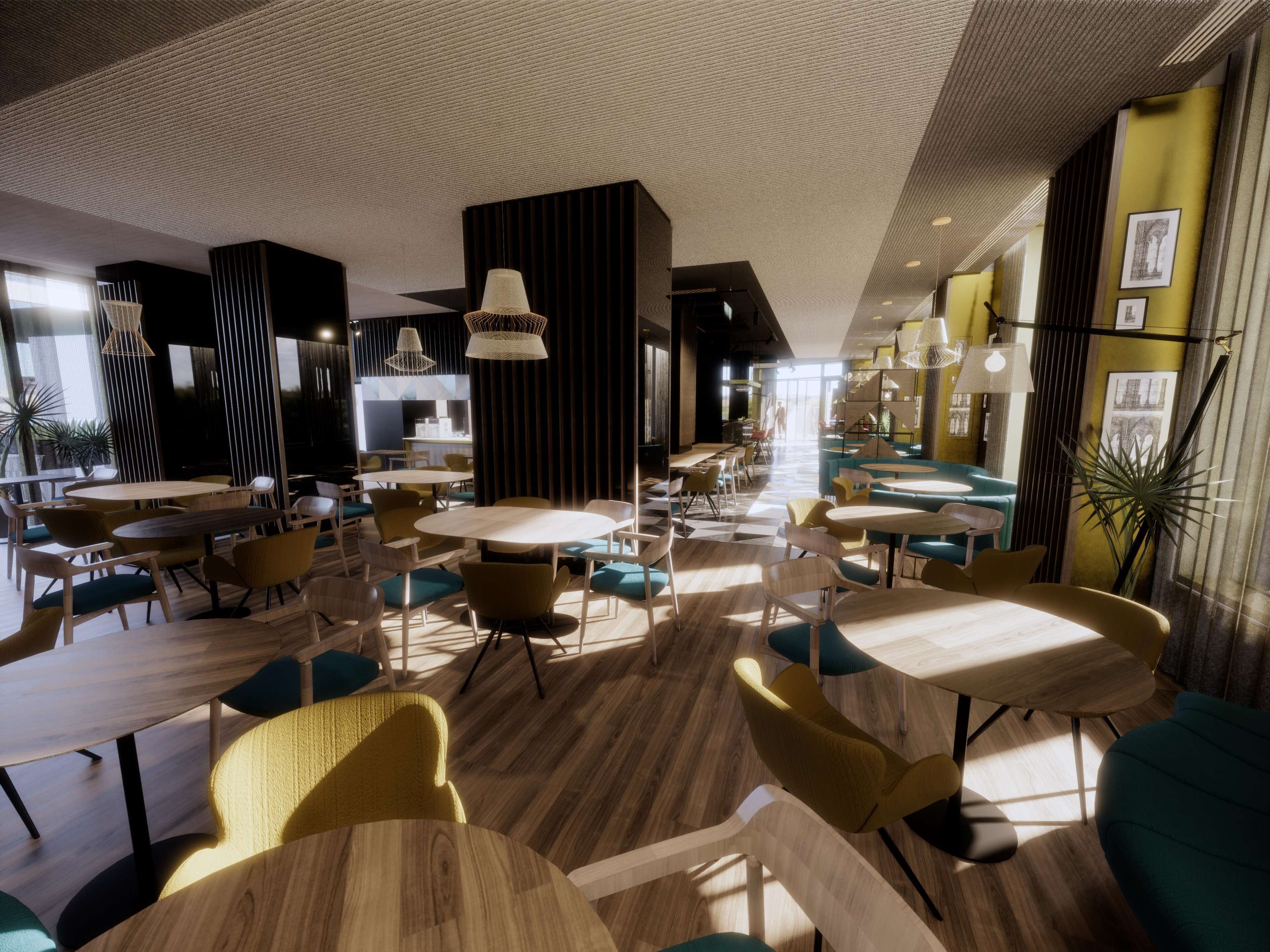 Ein modernes Restaurant mit runden Tischen und Stühlen, einer Küche und Blick auf die Straße.