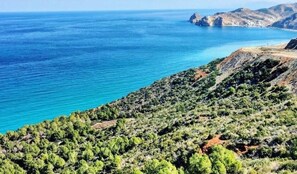A coastal landscape with a clear view of the sea and rocky terrain. - Top Floor Private Terrace with Sea View (Oued Laou)