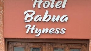 A wooden double door with multiple glass panels and a sign above reading "Hotel Babua Hynness." - Hotel Babua Hyness (Haridwar)