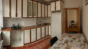 Comfort Condo | Private kitchen | Stovetop, freezer, dining tables