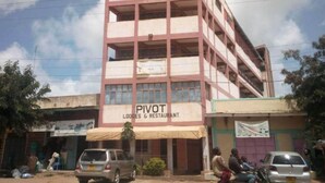 A multi-story building with a sign for "PIVOT Lodges & Restaurant." - Pivot Hotel (Mwingi)