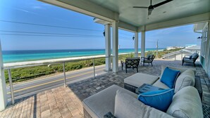 A covered outdoor seating area with a view of the ocean. - The Hidden Gem ~Luxurious Beachfront Home Near 30A! (Panama City Beach)