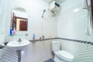 Shower, hair dryer, soap, toilet paper