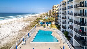 A hotel with a pool, beach view, and multiple balconies. - Sea Oats 606 is a Gorgeous Gulf Front 3 BR - with Free Beach Service for 4 by RedAwning (Fort Walton Beach)