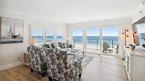 A spacious living room with a sofa, armchairs, and a coffee table. Large windows offer a view of the ocean. - Sea Oats 606 is a Gorgeous Gulf Front 3 BR - with Free Beach Service for 4 by RedAwning (Fort Walton Beach)