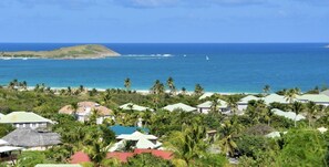 A coastal resort with multiple bungalow-style buildings, a beach, and a clear view of the ocean. - SUNSEEKER SXM (Marigot)