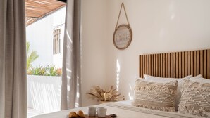 A neatly made bed with a book, two cups, and a croissant, a wooden headboard, and a wall-mounted sign that reads "HOME". - Modern Gated Townhome. 3BR for 6 guests. Walk to Restaurants. Private Jacuzzi (Tulum)
