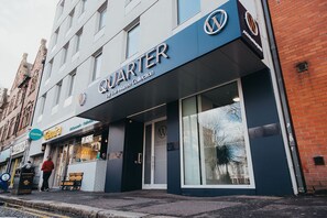 A building with a sign reading "QUARTER by The Warner Collection."
