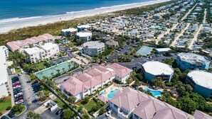 An aerial view of a coastal residential area with multiple buildings, a beach, and a clear sky. - Montego Bay (St. Augustine)