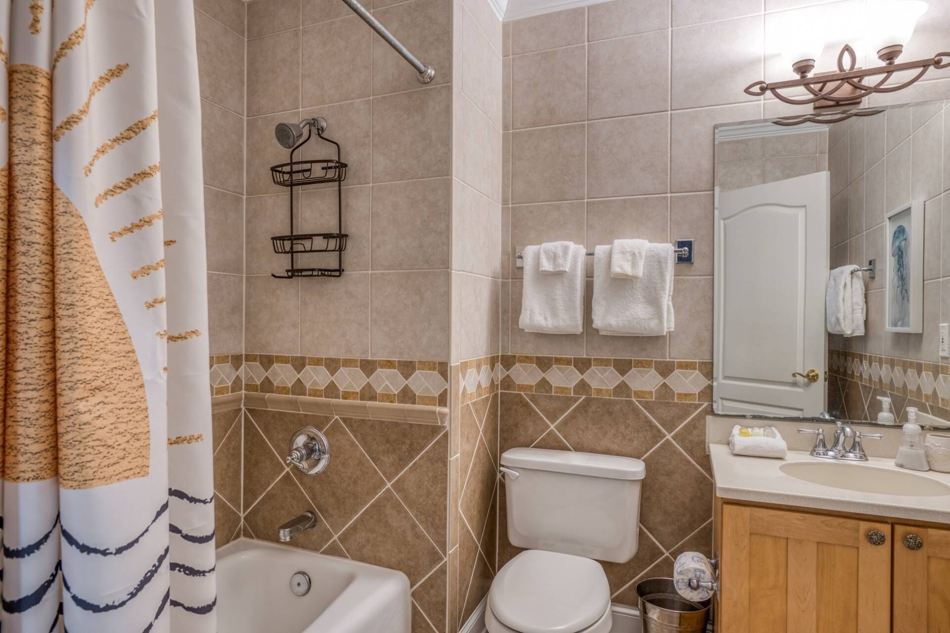 A bathroom with a bathtub, toilet, sink, and towel rack.