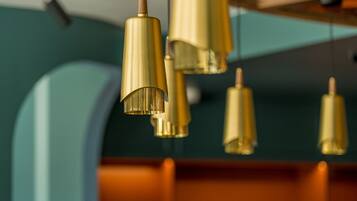 A close-up of a ceiling with multiple golden pendant lights.