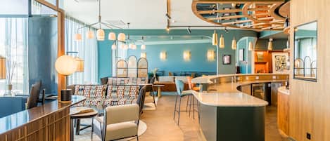 A modern interior with a bar area, seating, and a counter.