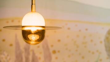 Un luminaire suspendu avec un abat-jour en verre transparent et une ampoule visible.