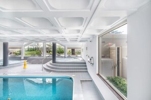 Relax by the pool with a stunning view of the surrounding landscape.