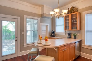 Enjoy cooking in this well-equipped kitchen with a central island, coffee maker, and ample seating.