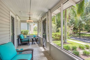 Relax on the covered porch with a seating area and enjoy the view of the surrounding neighborhood.