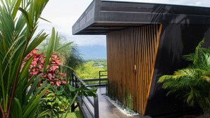 A modern building with a wooden slatted wall and a black roof. - Panorama Pueblo Tapao  (Montenegro)