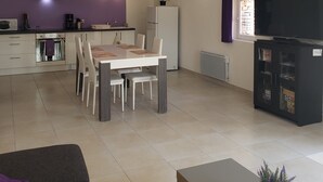A modern apartment with a kitchen, dining area, and living room. - 2 Bedroom Apartment in Anduze (Anduze)