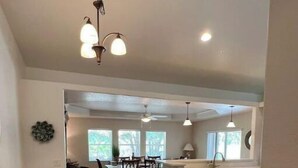 A spacious kitchen with a dining area, featuring a large island, ample natural light, and modern appliances. - Cozy 3-Bedroom Home in North Port (North Port)