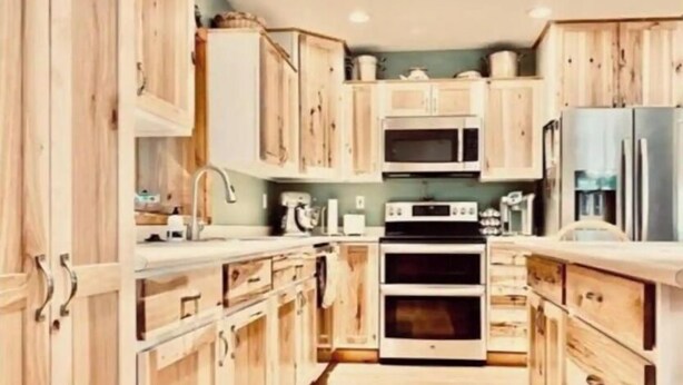 A compact kitchen with wooden cabinets, a microwave, an oven, and a refrigerator. - The Good Place: Lakehouse Near Dunbar ATV Trails/On Blue Ox Trails (Fence)