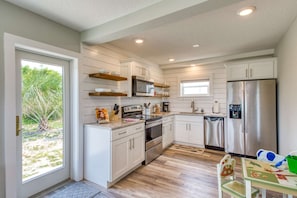 Enjoy cooking in this well-equipped kitchen with an oven, microwave, and refrigerator.