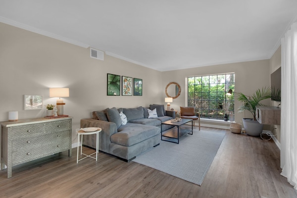 The living room has a comfortable sectional sofa with a seat for everyone.
