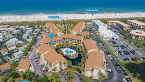 An aerial view of a resort with a central pool, beach walkover, and A1A Beach Boulevard. - Ocean Villas #76 (St. Augustine)