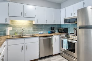 Enjoy cooking in this well-equipped kitchen with a microwave, toaster, and oven.
