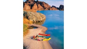 A beach with kayaks and people.