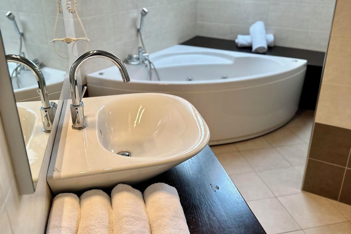 junior suite, 1 bedroom, accessible, garden view | bathroom | jetted bath, rainfall showerhead, free toiletries, hair dryer