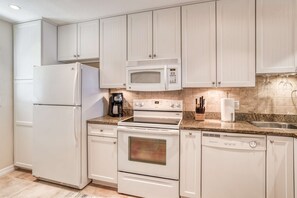 Enjoy cooking in this well-equipped kitchen with a microwave, coffee maker, and dishwasher.