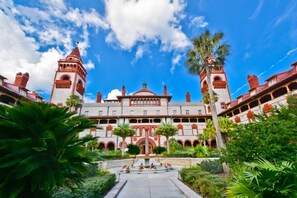 Experience the blend of traditional and modern architecture at this grand hotel, featuring a central building with two towers and a serene courtyard.