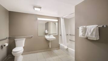 A bathroom with a toilet, sink, and bathtub.