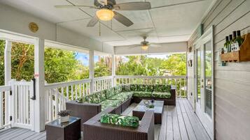 Relax on the covered deck with a sofa and wicker side tables.