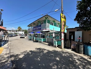 A street view with a building featuring a sign for 'Ultras'.